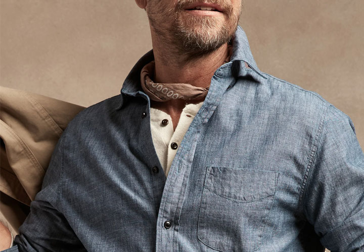 Manly model wearing ivory henley under his chambray shirt.