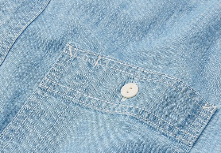 Close-up of chambray utility shirt pocket details. 