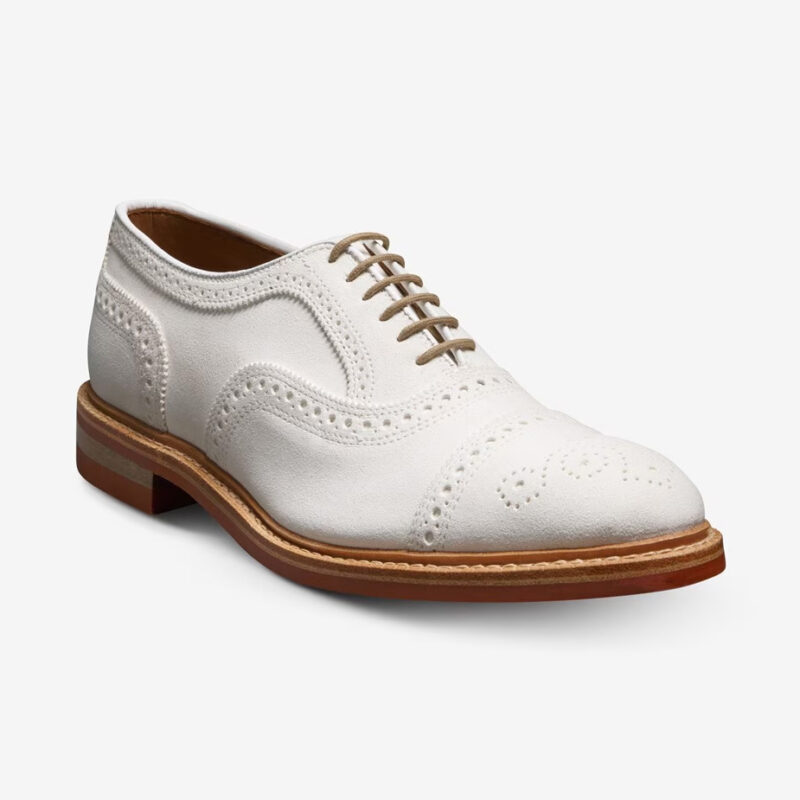 Three-quarter front view of Allen Edmonds Strandmok Cap-toe Oxford in white suede.