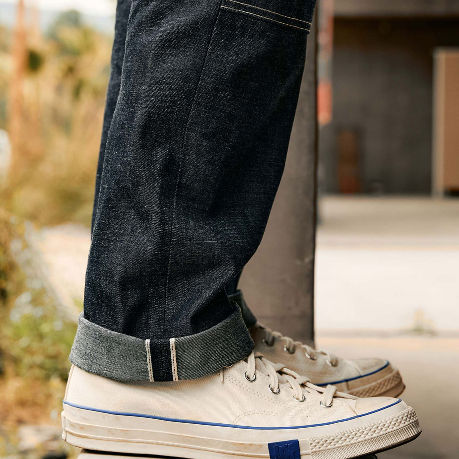 Side view of imogene + willie workpant cuffed with canvas sneakers