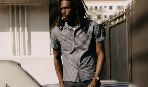 Male model wearing Taylor Stitch camp collar Tulum Shirt in Midnight Stripe.