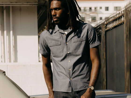 Male model wearing Taylor Stitch camp collar Tulum Shirt in Midnight Stripe.